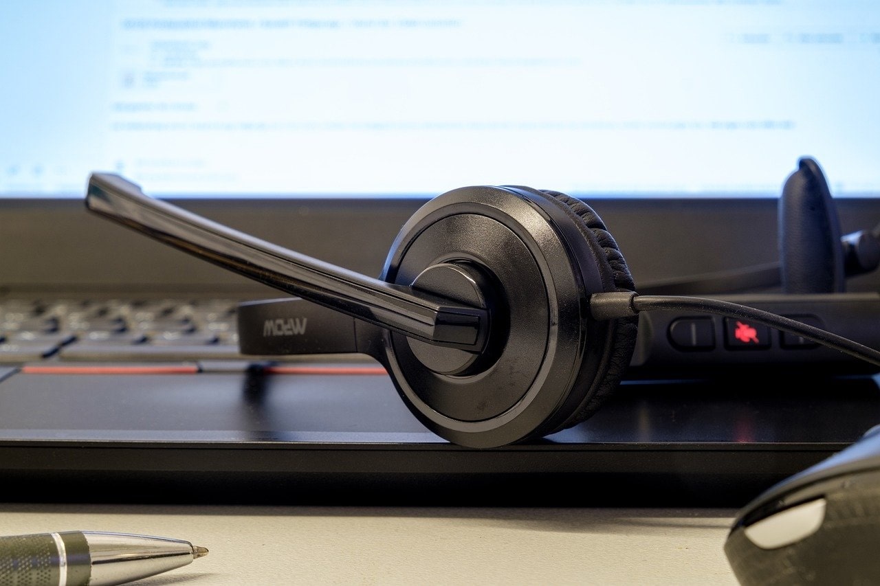 Photo of a headset resting on a laptop