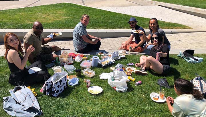 Beanstalk team sat on grass with potluck lunch